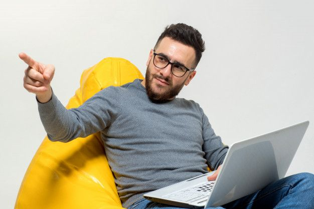 Man with a laptop pointing toward the virtual tour experience